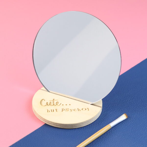 Compact mirror with 'Cute but Psycho' engraved