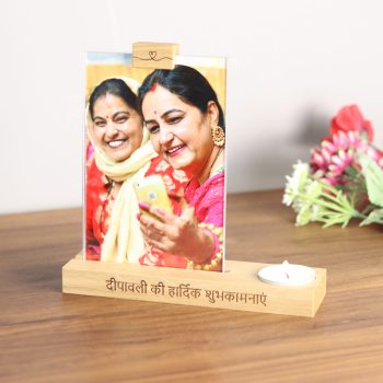 Phot frame with two indian ladies in traditional costume taking a selfie. The photo frame is mounted in an oak based with 'Happy Diwali' engraved in Hindi