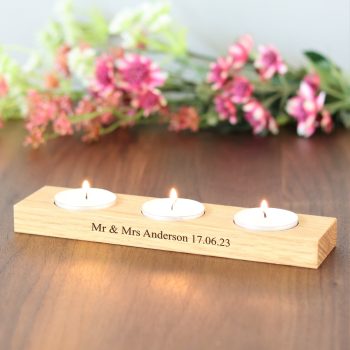 Solid oak rectangular candle holder with holes for three tea lights to be placed in the holes. Message engraved on the front.